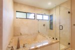 Master bath features custom walk in shower and large soaking tub
